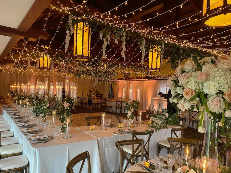 Hanging florals beneath a twinkle-light ceiling at The Lodge at Torrey Pines wedding reception