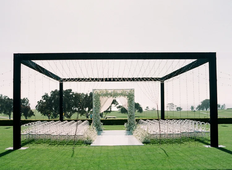 Draped ceremony arch with twinkle-light pavilion at The Lodge at Torrey Pines wedding