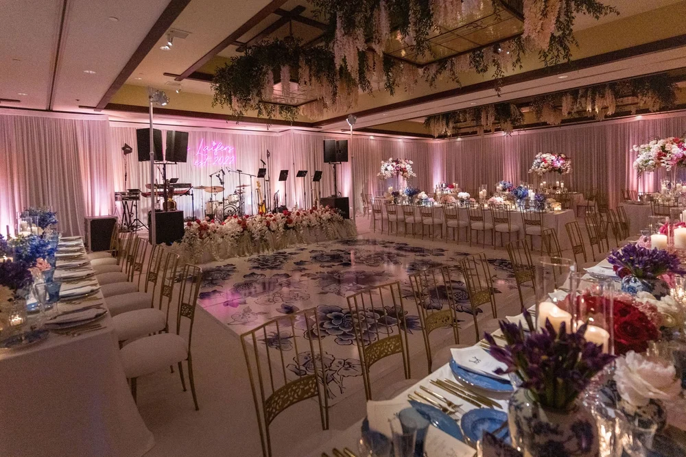 Floral chandeliers, pink uplighting, and patterned dance floor at The Lodge at Torrey Pines wedding