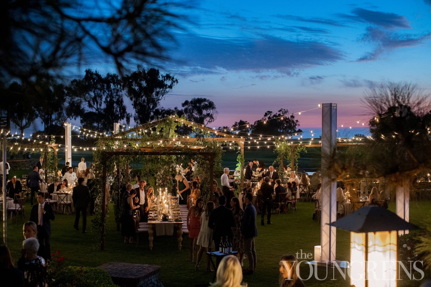 Blue-hour cocktail hour beneath cafe lights at sunset at The Lodge at Torrey Pines wedding