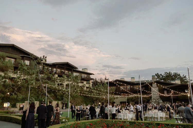 Sunset cocktail hour beneath cafe lights at The Lodge at Torrey Pines wedding