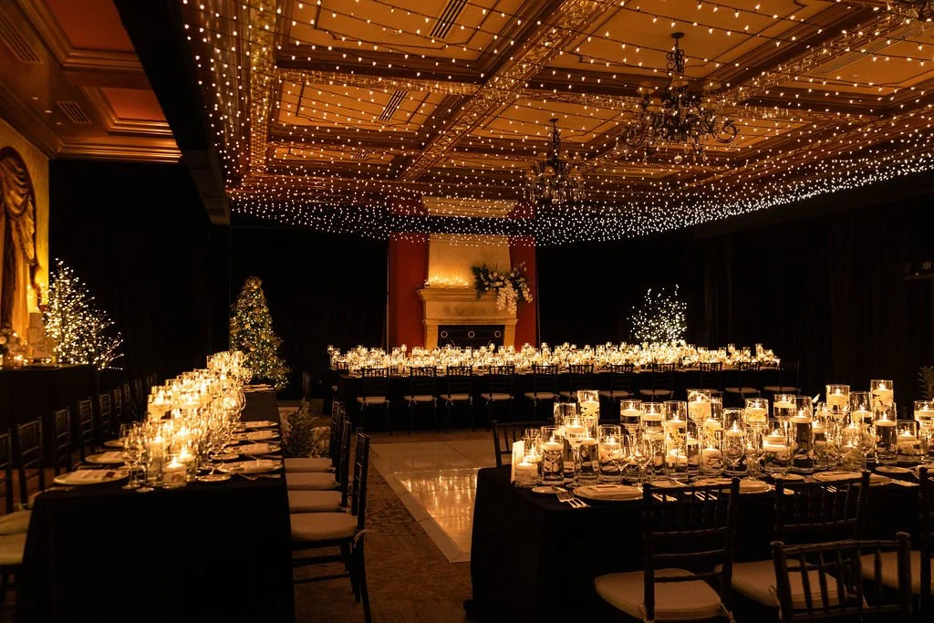 Elegant warm twinkle light canopy over formal reception