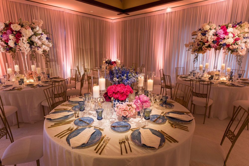 Pink and blue uplighting accenting a floral tablescape at The Lodge at Torrey Pines wedding