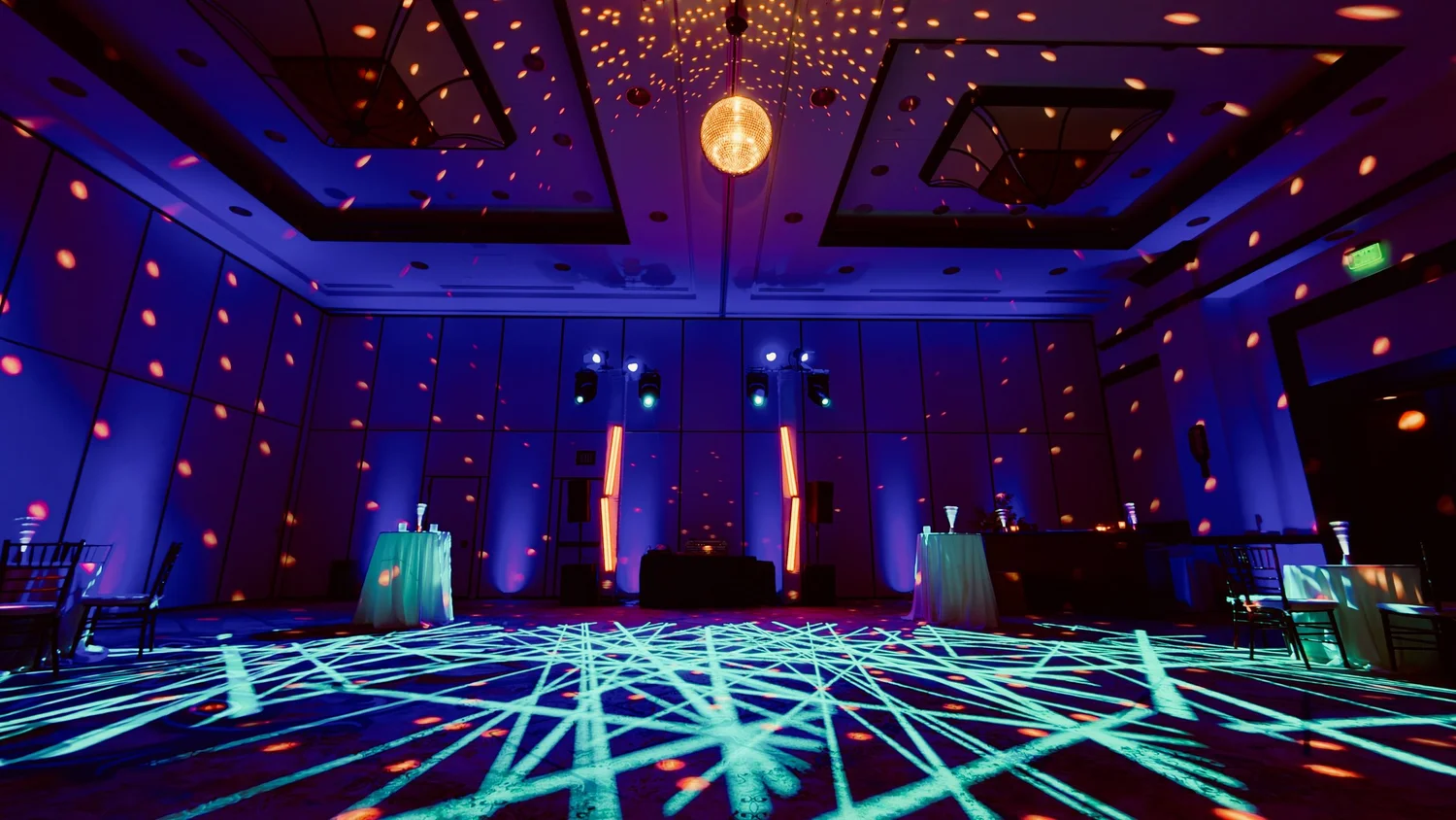 Rented disco ball rigged in a hotel ballroom with a pin spot scattering light across the room