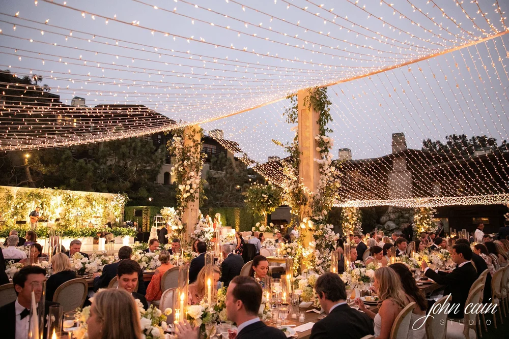 Twinkle-light canopy glowing over an evening reception at The Lodge at Torrey Pines wedding