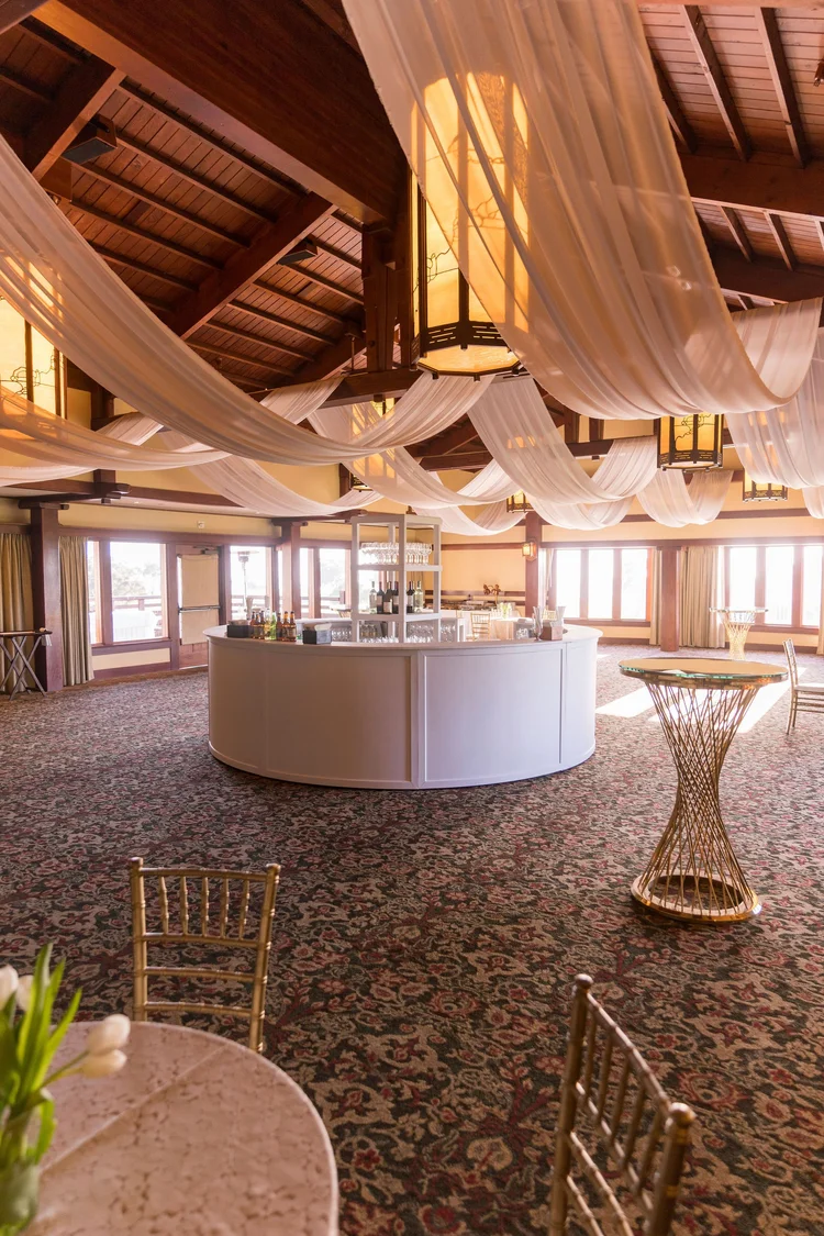 White ceiling drape and ambient lighting framing the round bar at The Lodge at Torrey Pines wedding