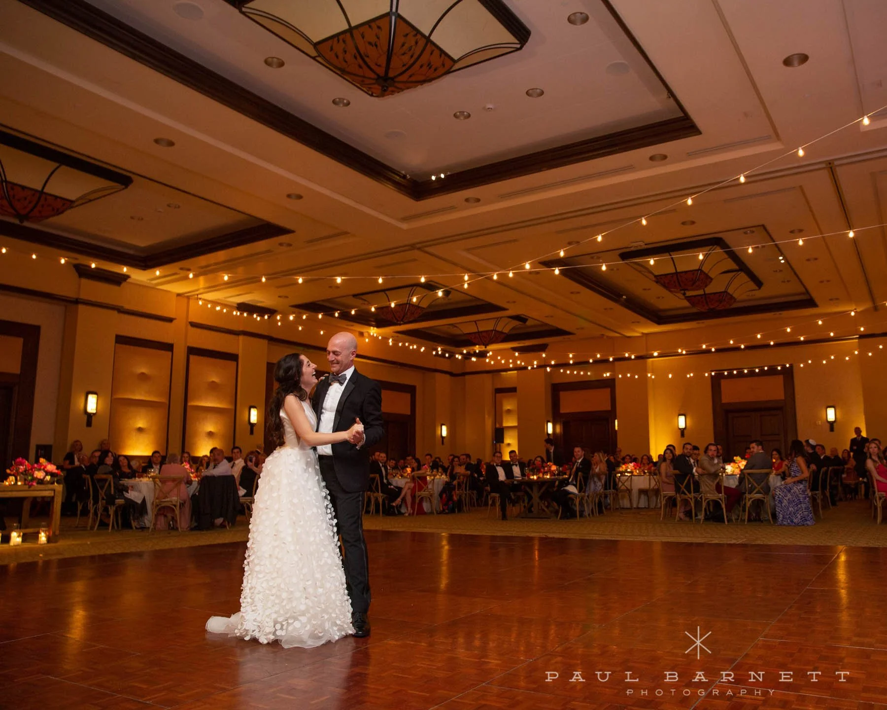 Market lights attached to existing venue structure with draping