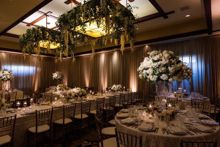 Custom hanging floral chandelier installation above banquet tables at The Lodge at Torrey Pines