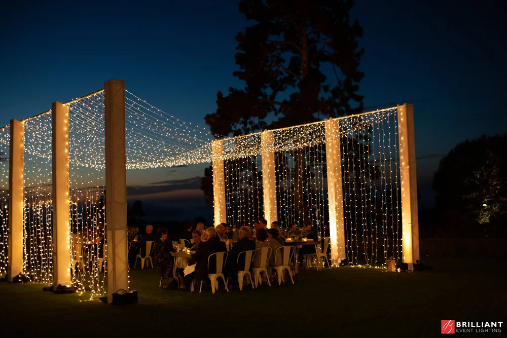 Twinkle-light archways glowing on the Arroyo Terrace at night, The Lodge at Torrey Pines wedding
