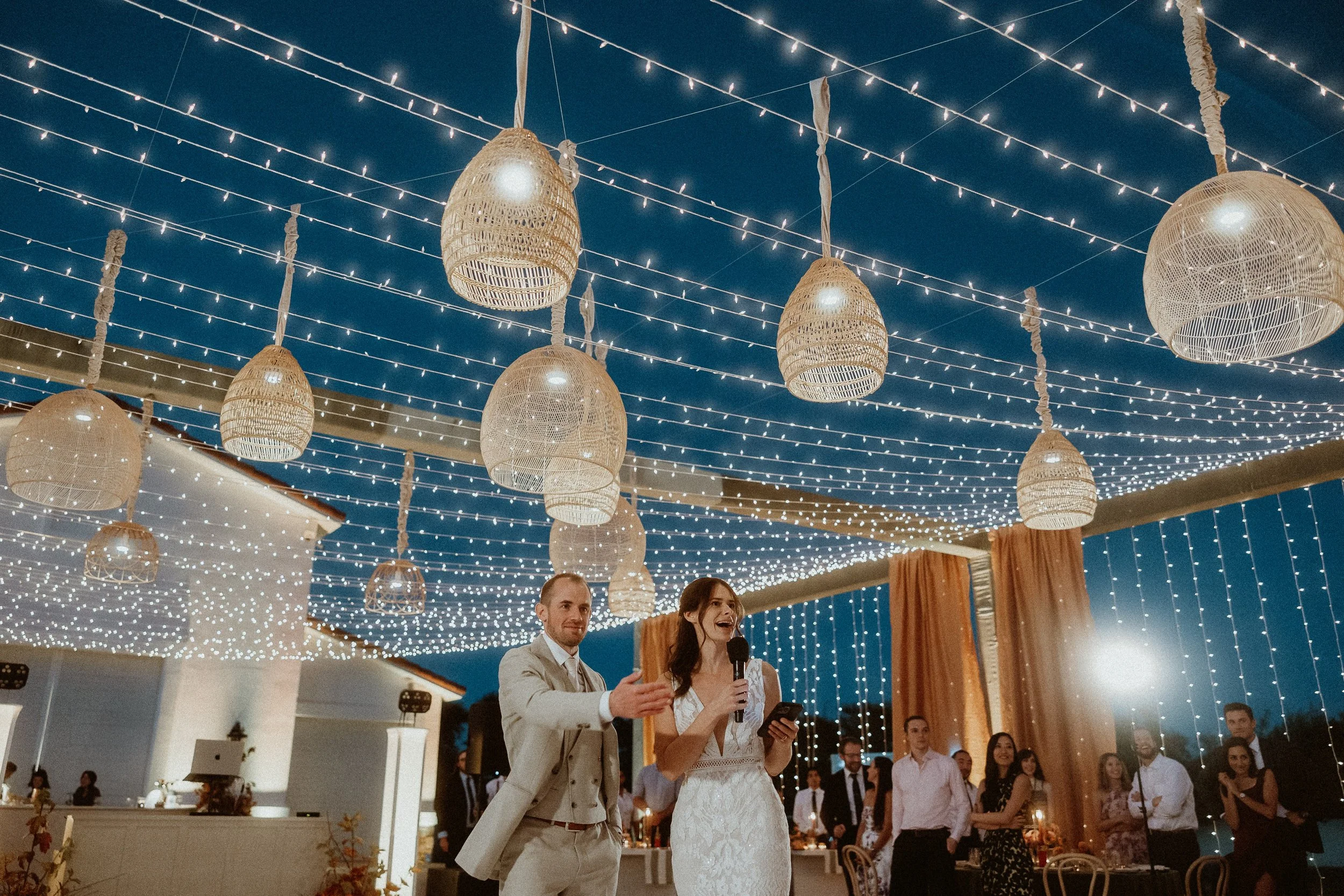 String light canopy over outdoor wedding reception