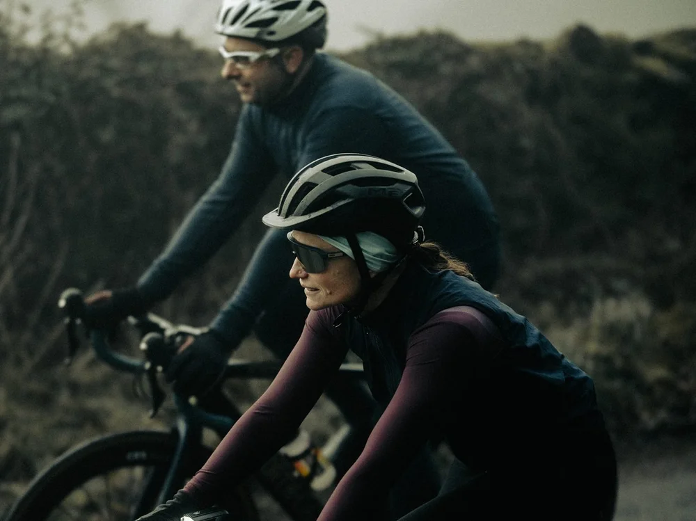 Dr Liz Mahon leading Dr Howard Hurst on their road bikes along a misty lane