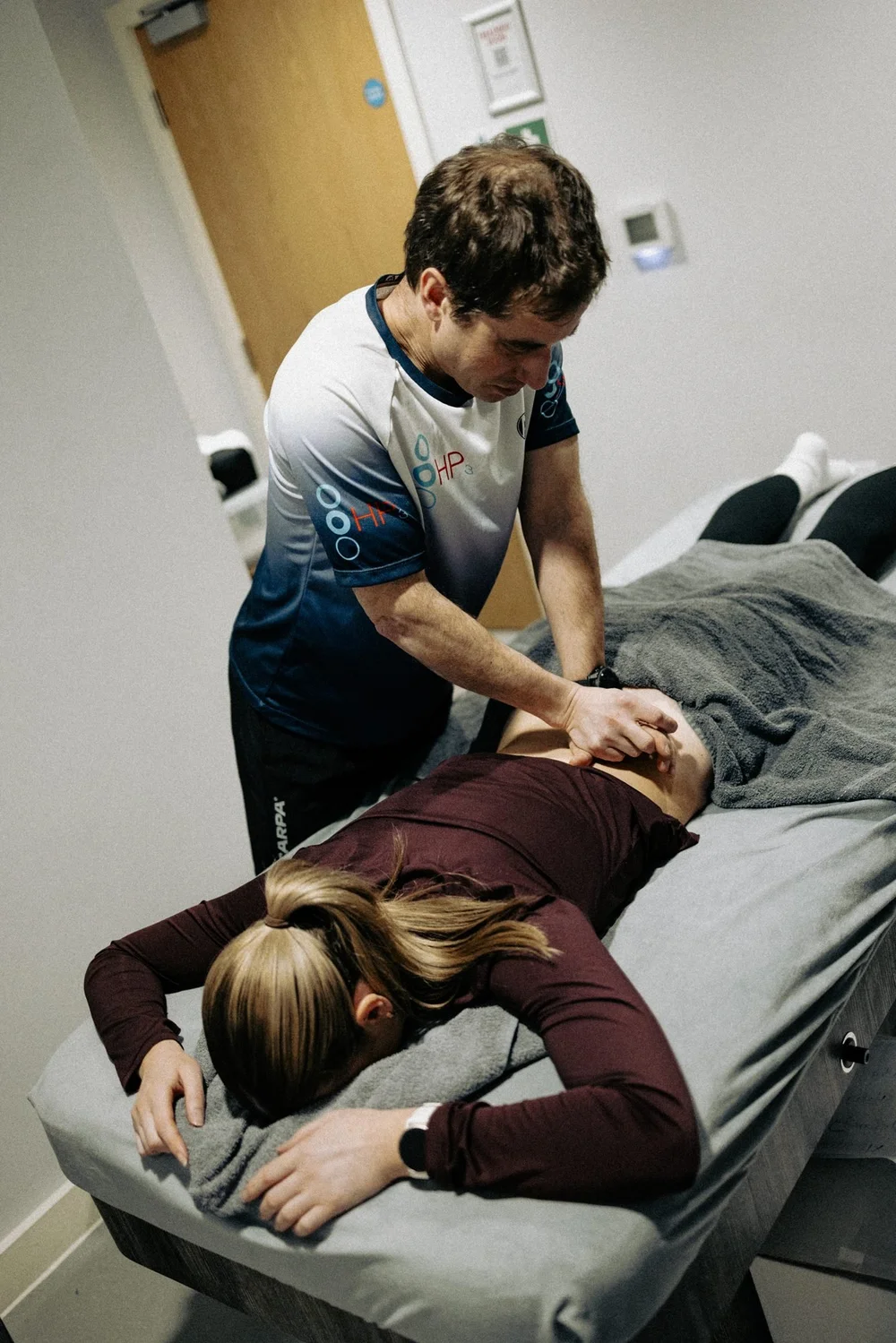 An HP3 physiotherapist giving hands-on treatment to a patient's lower back at Worsley Physiotherapy Clinic