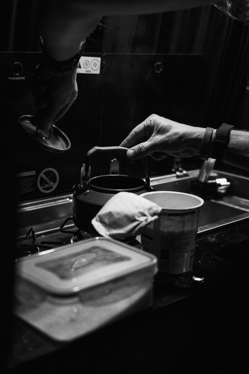 Hot food being prepared on a camping stove at the crew van during the West Highland Way Race