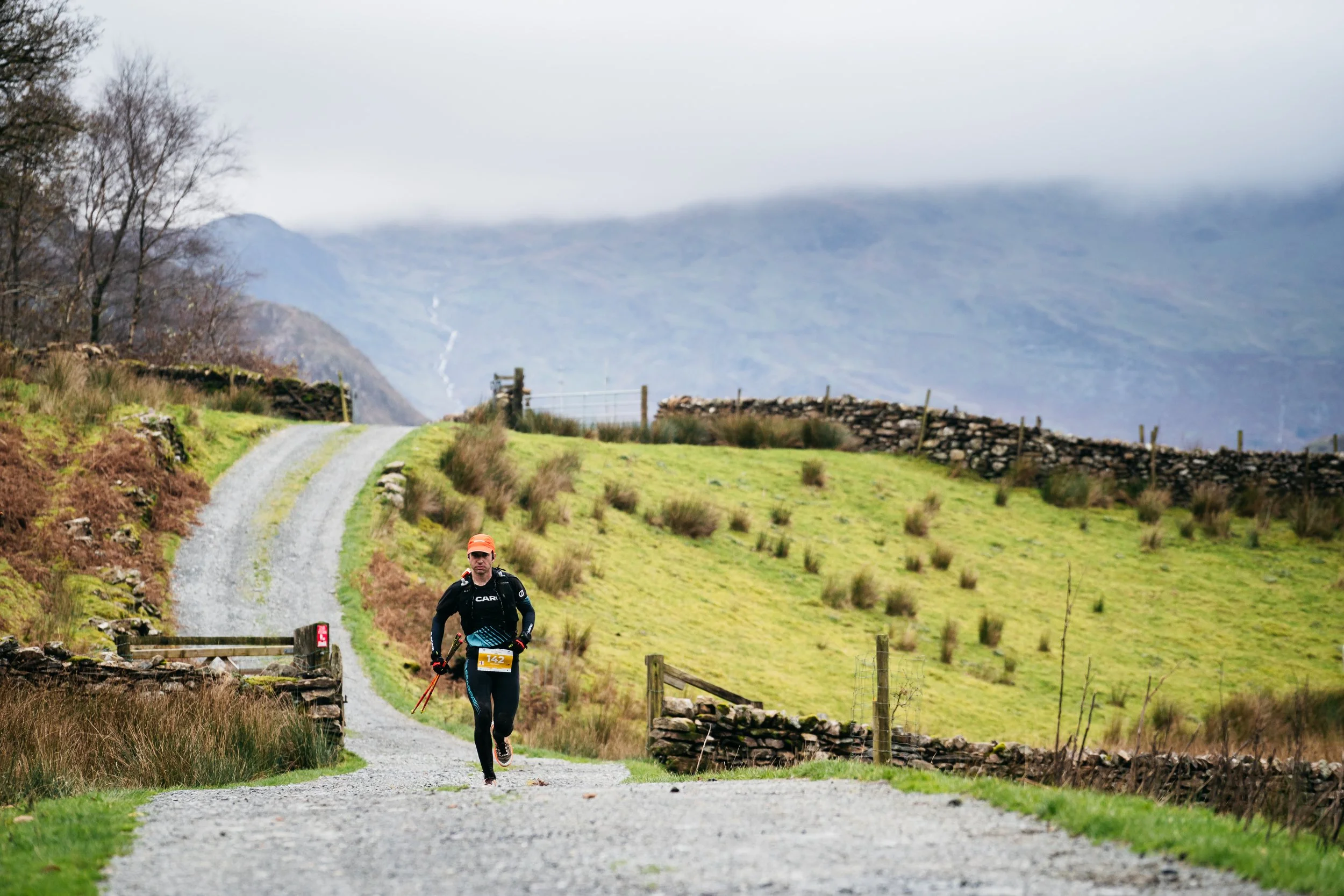 Trail runner descending a technical mountain path mid-race