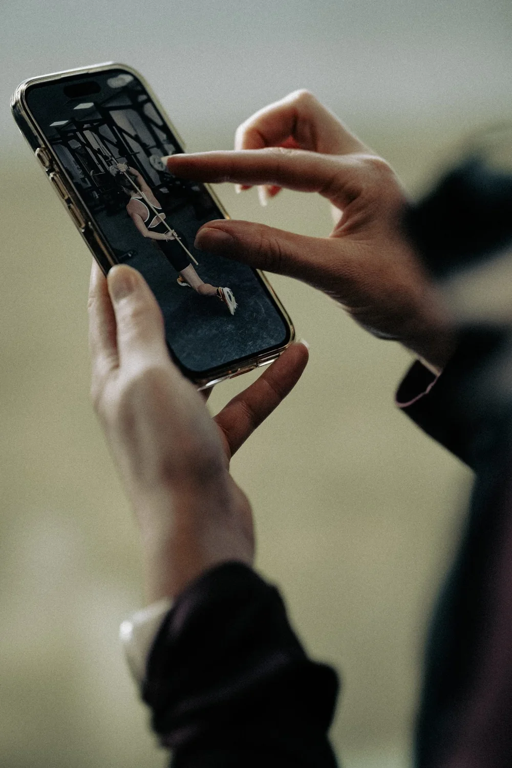 A patient reviewing a movement assessment video with their physiotherapist on a phone