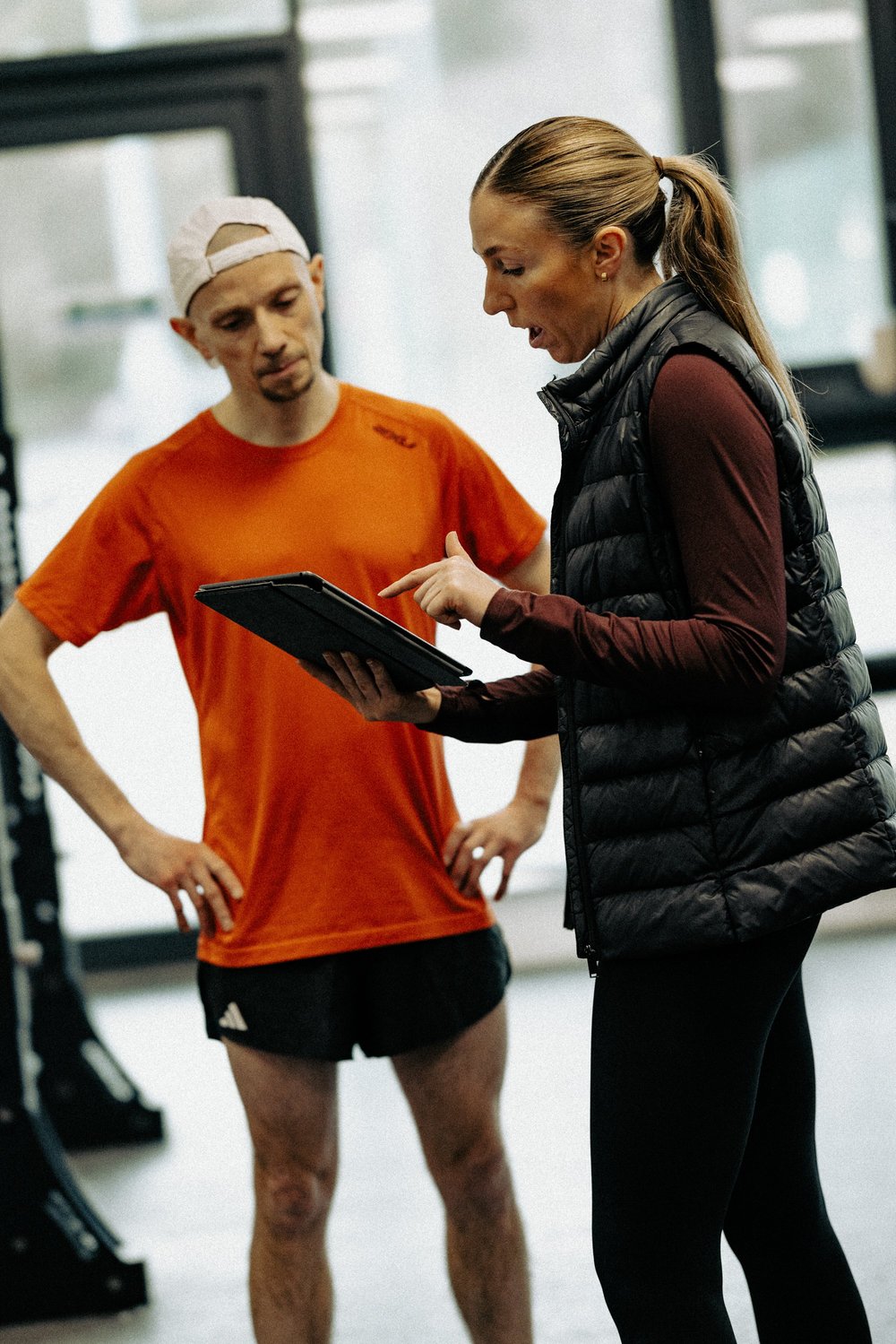 An HP3 coach and athlete reviewing season data together on a tablet