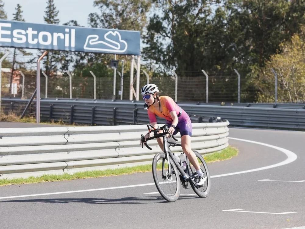 A triathlete on a time-trial bike cornering on the Estoril circuit