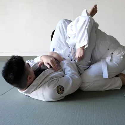 Two students working a ground position in jiu-jitsu