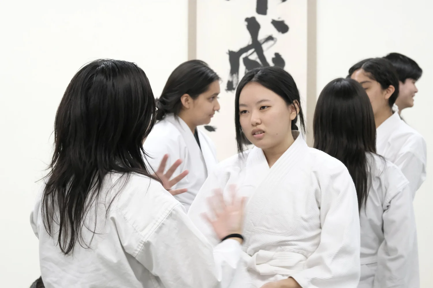 Budo Accelerator students in their gis practicing together in the dojo