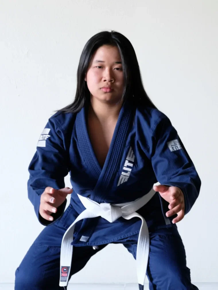 A Budo Scholar student in a navy jiu-jitsu gi, set in a low, ready stance