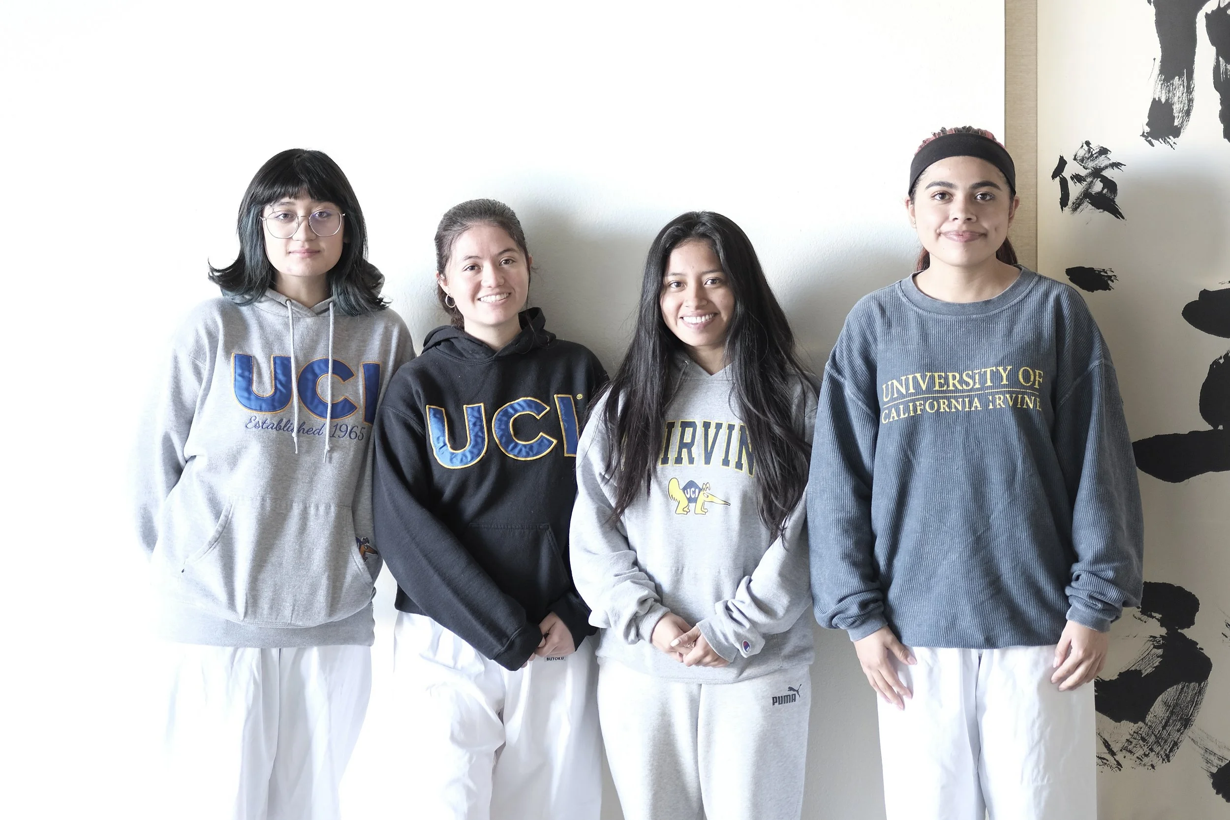 Four Budo Accelerator students from UC Irvine standing together in the dojo
