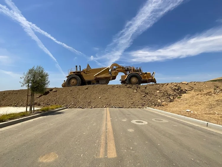 CAT 657 scraper crossing a new road