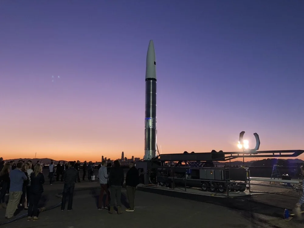 Prototype rocket on its launch rail at dusk