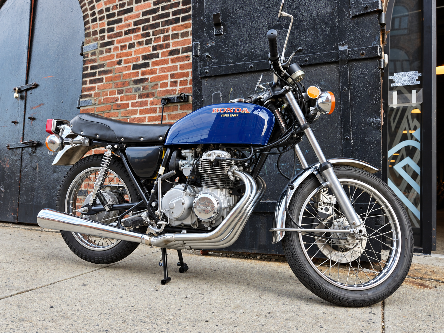 Blue Honda CB400F viewed from the front three-quarter angle