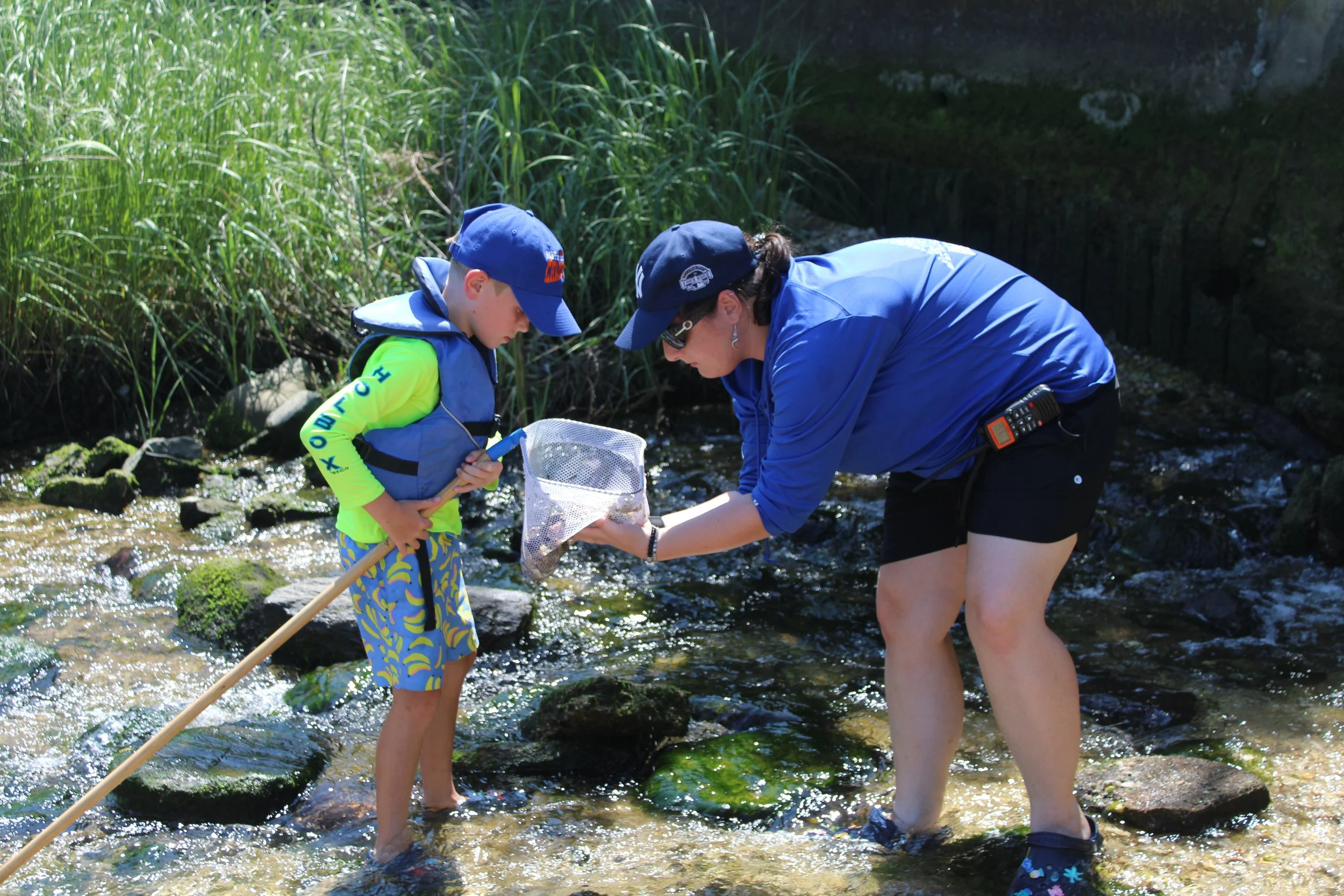 A child participating in hands-on marine education with a WaterFront Center educator