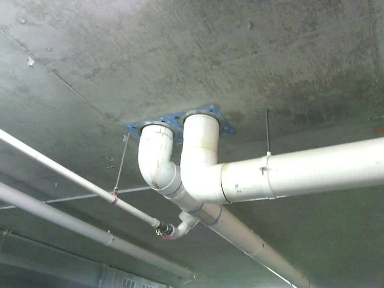 PVC stack pipes under the slab of an apartment building car park