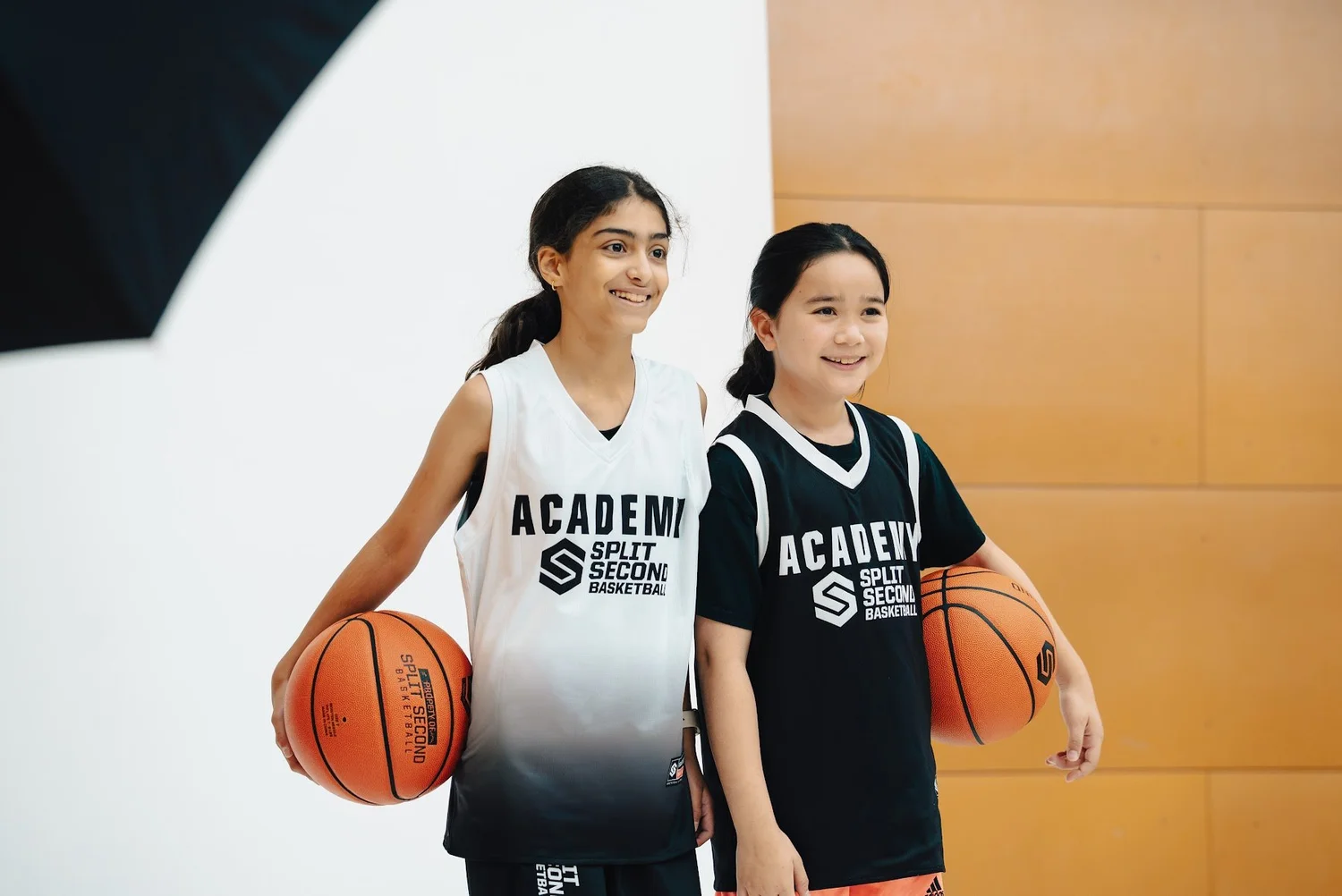 Two Academy players smiling on the photo set