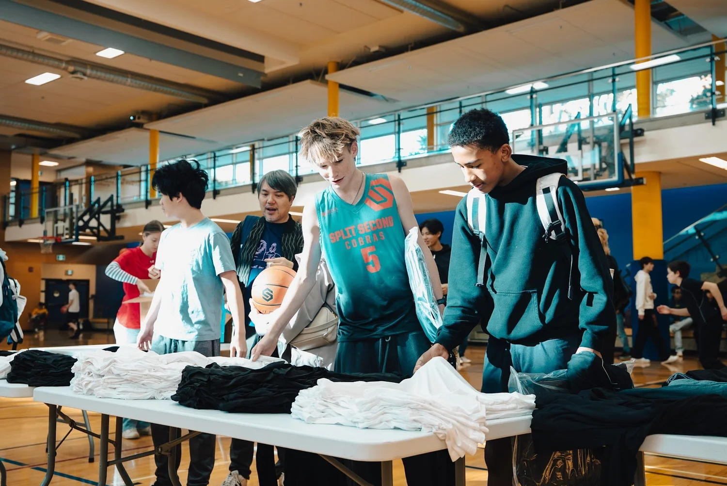 Cobra players picking up their gear packages at the gear tables
