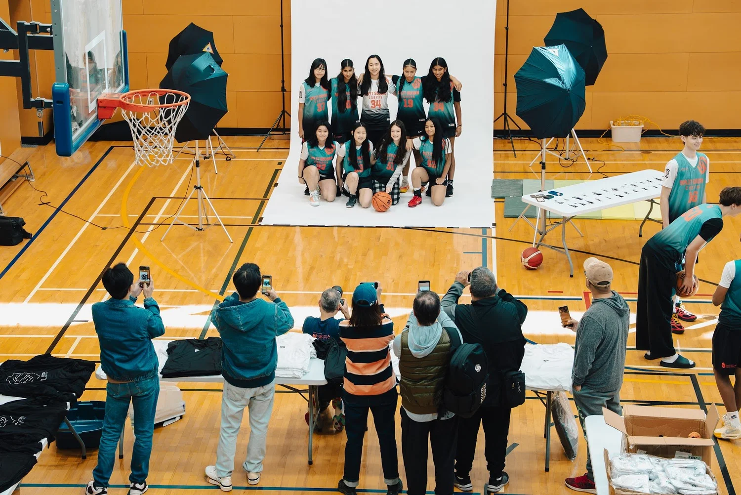 Families watching a Cobra team photo being taken