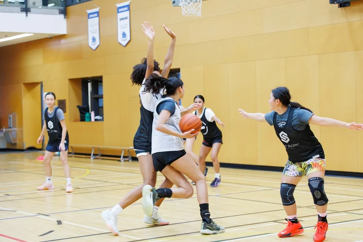 A defender walls up at the rim with both hands straight up