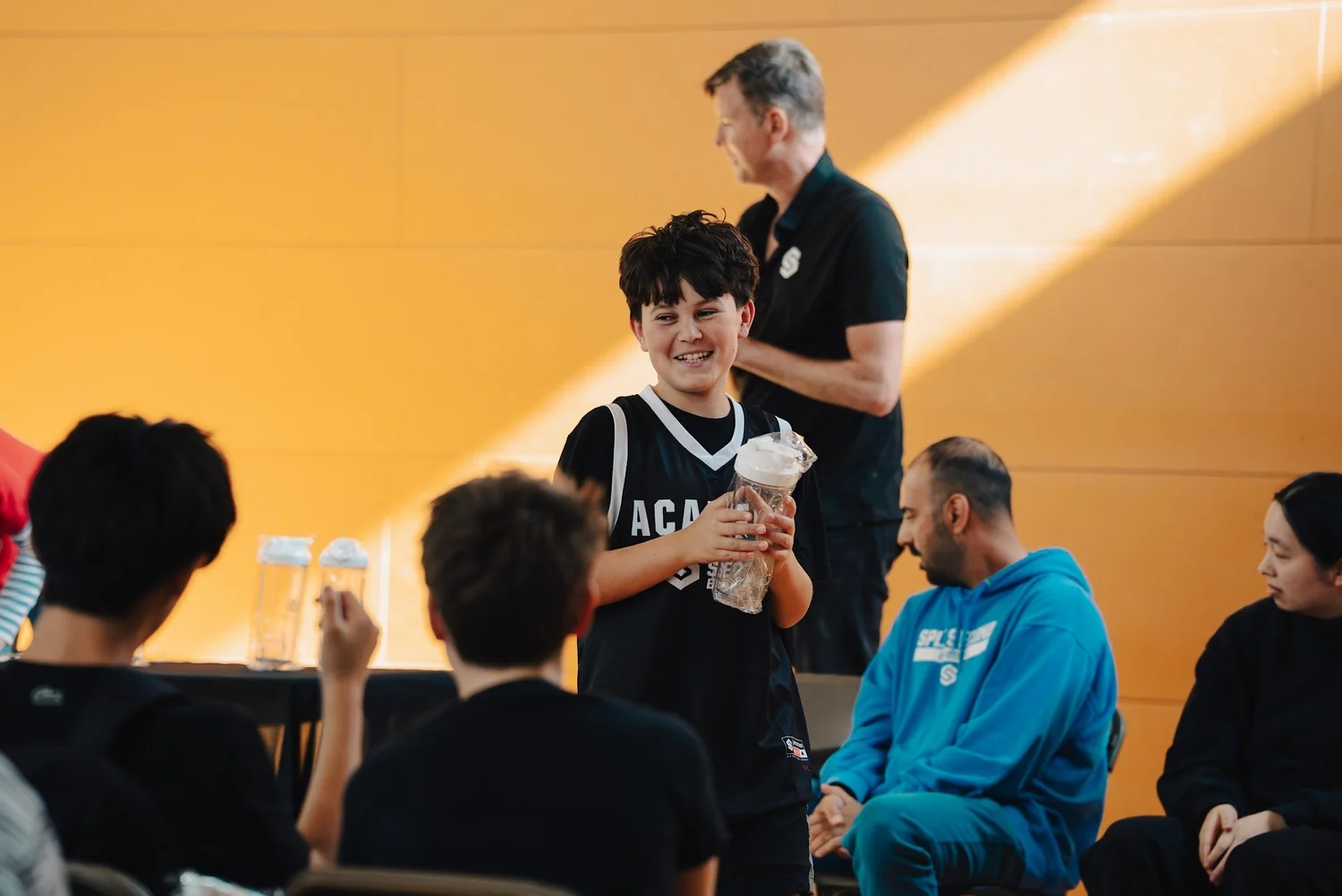 An Academy player smiling on the way up to collect a Kahoot prize