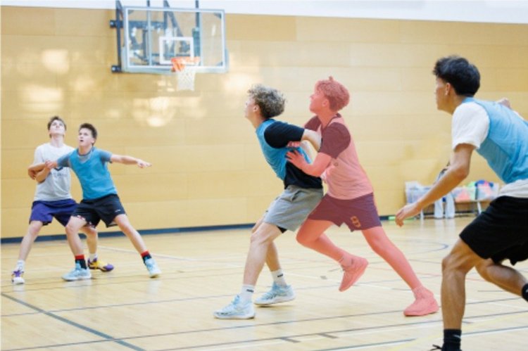 A player steps in and pushes their check from behind as the shot goes up