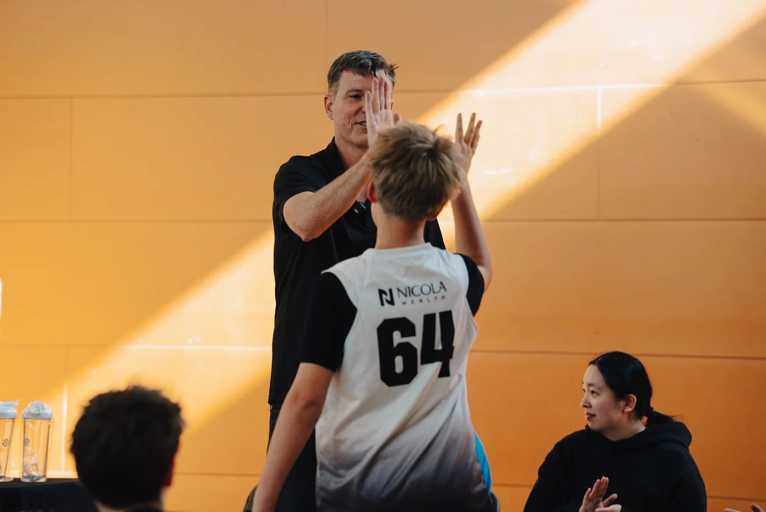 A player high-fiving on the way to pick up a Kahoot prize
