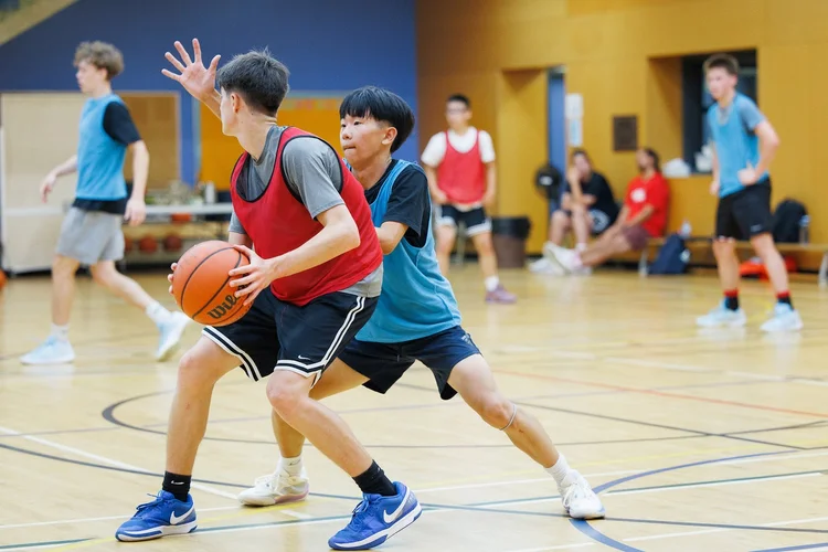 A defender pressures the ball handler
