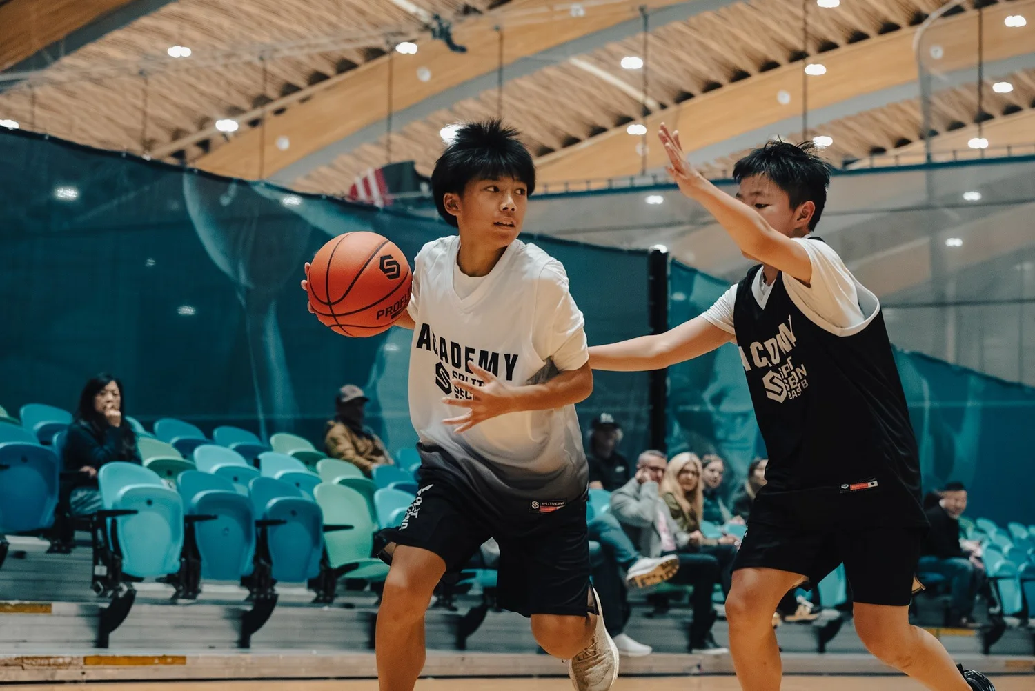 An Academy ball handler drives while a defender stays attached