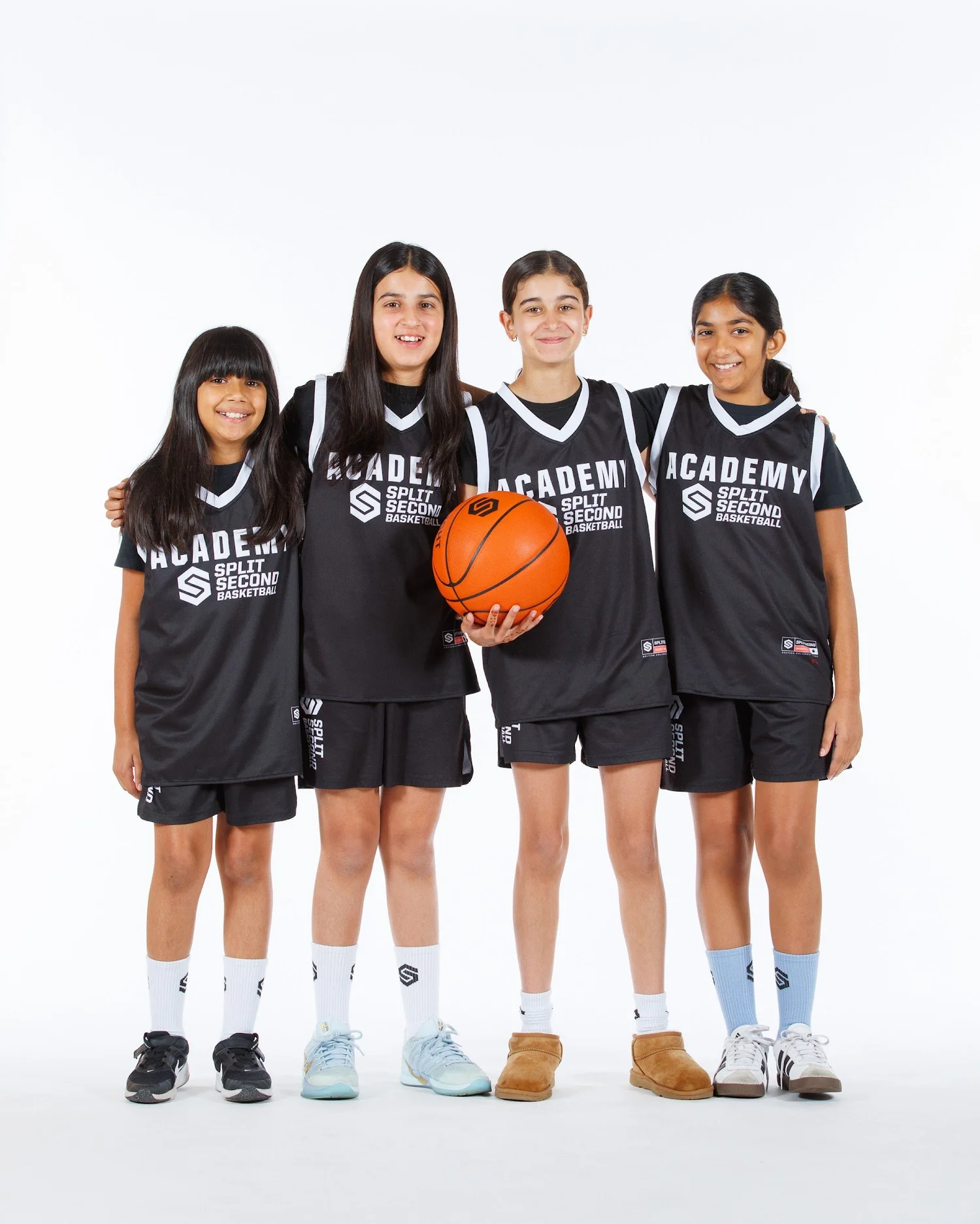 Four Academy girls with arms around each other at Community Day