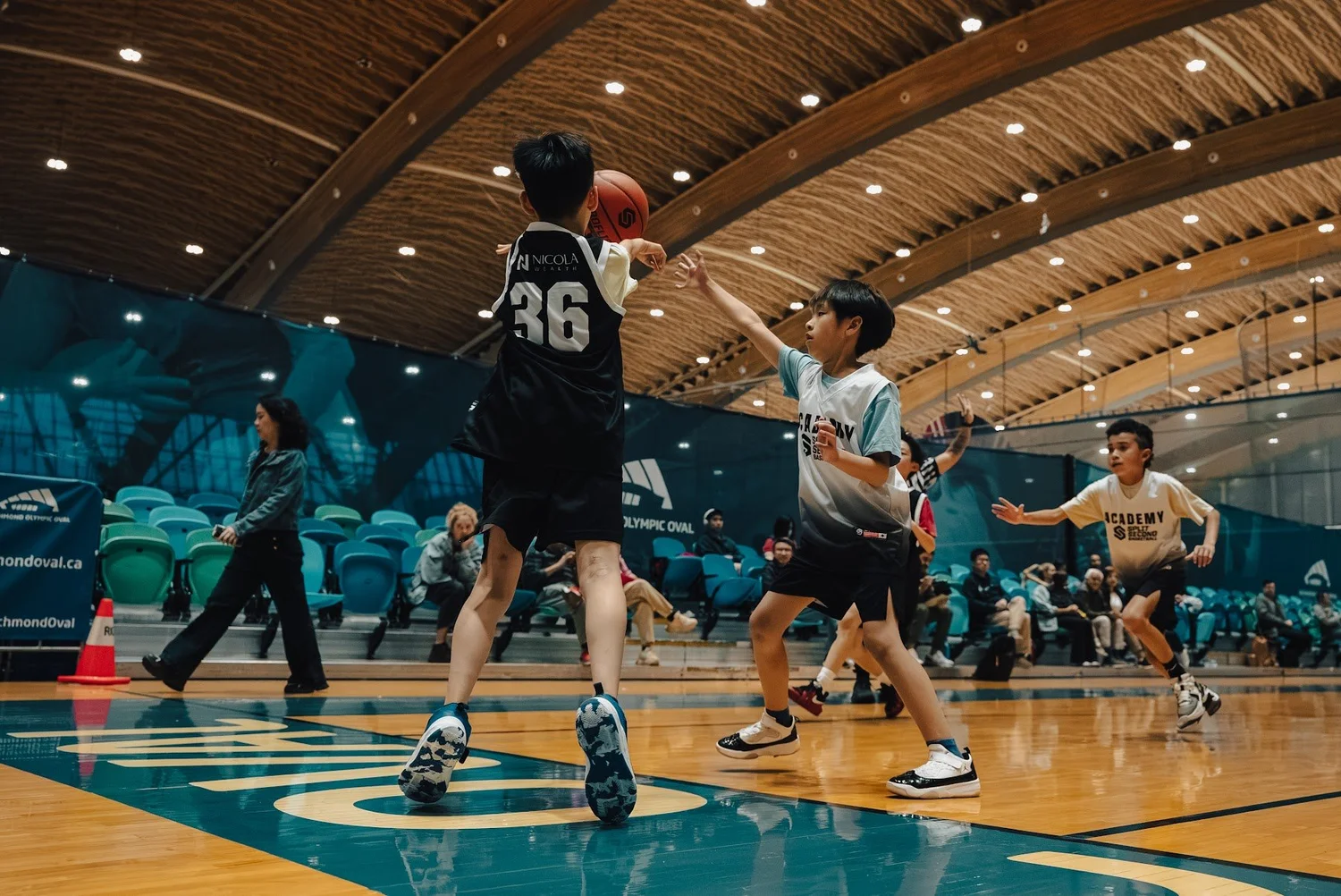 An Academy player rises for a jump shot over a defender