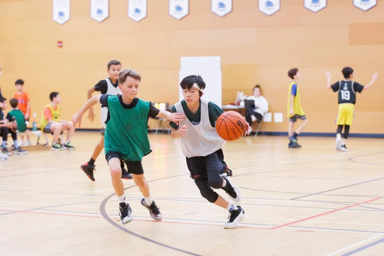 A defender stays attached to the ball handler's hip and shoulder