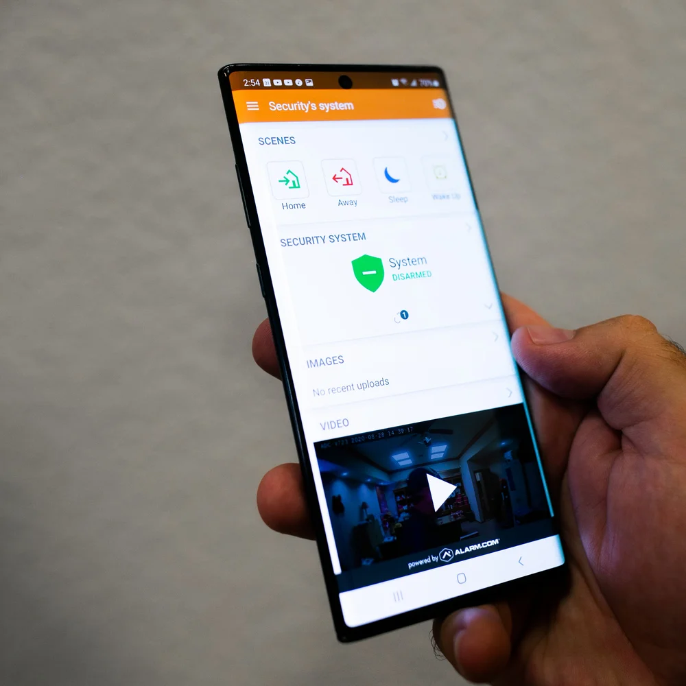 Boyd customer checking the Alarm.com app on a phone