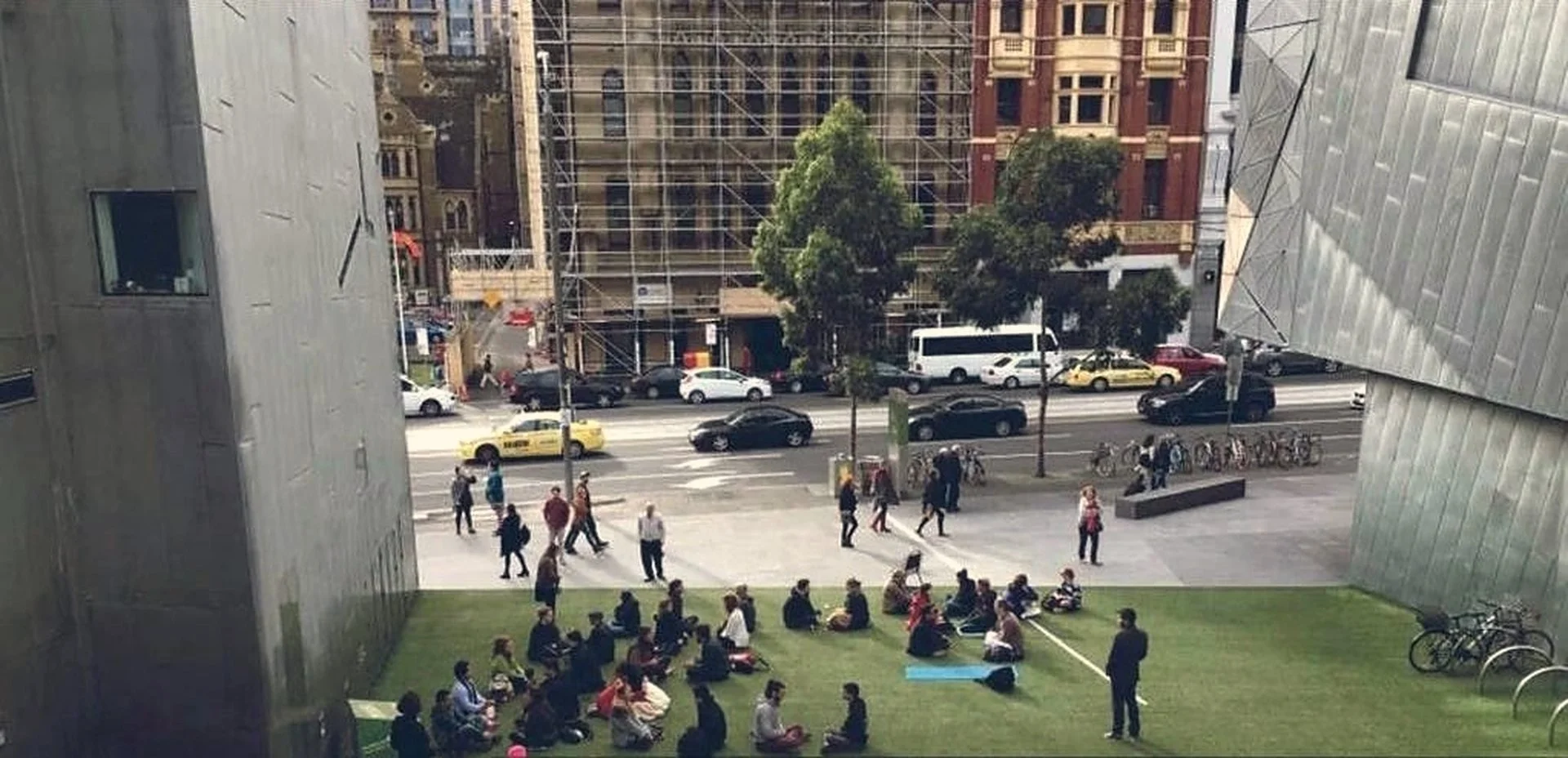 Pairs gazing on the grass at Federation Square, Melbourne