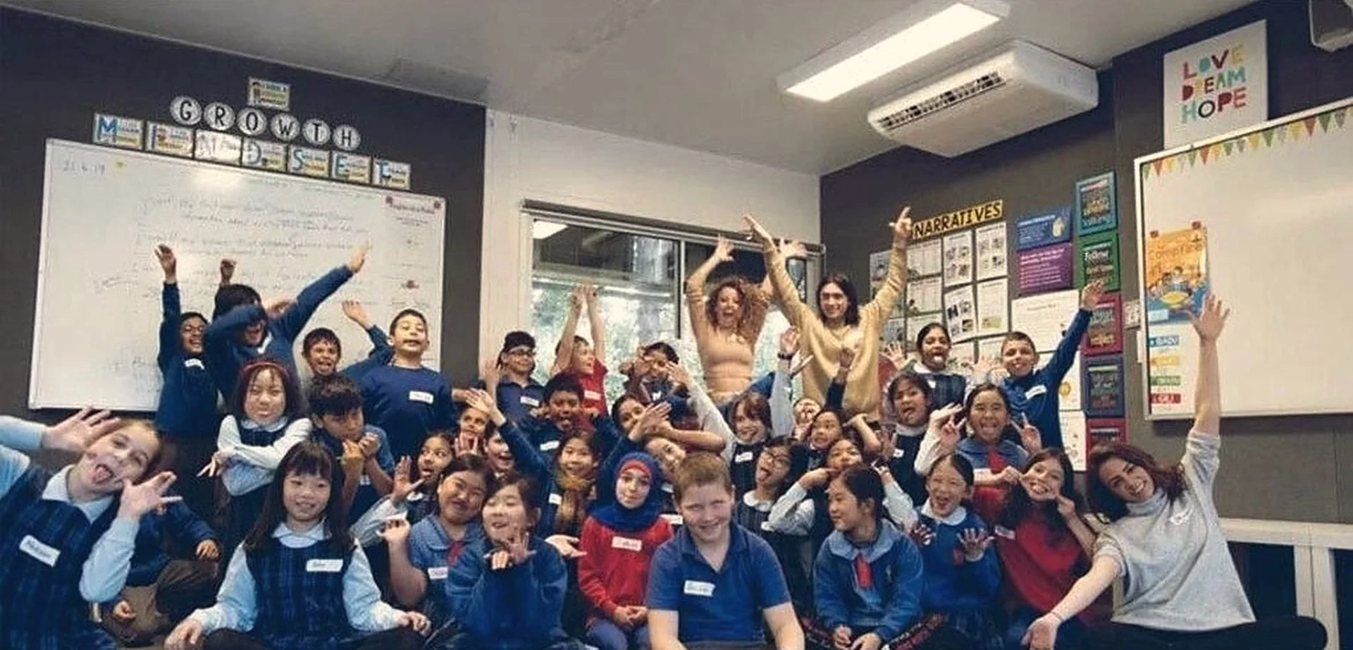 Penshurst Public School program, children with their arms raised