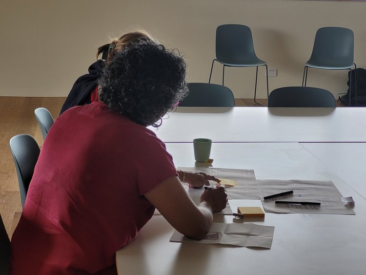 Two women interact as they complete a storyboard 