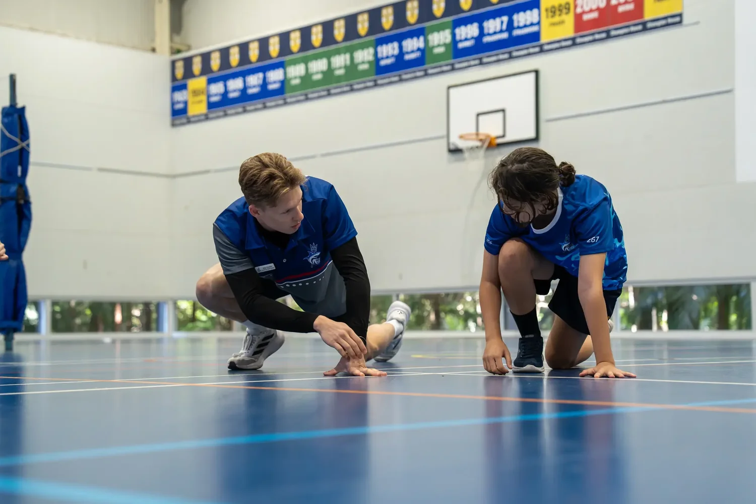 A Sharks coach in the current coaching polo leading an interactive athlete activity