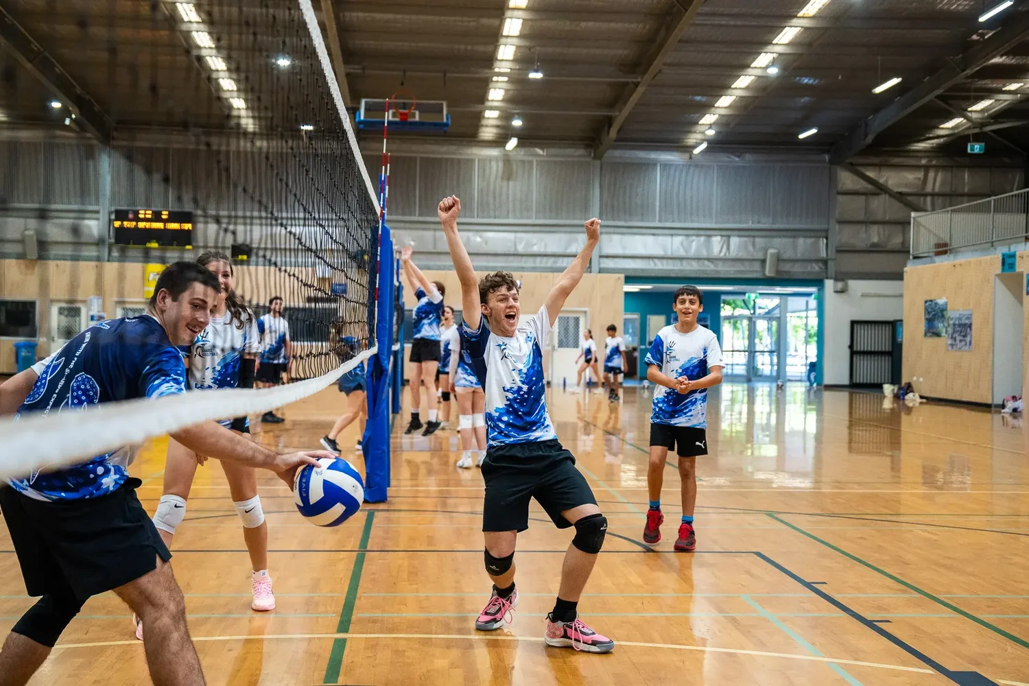 Sharks athletes celebrating during an on-court volleyball session