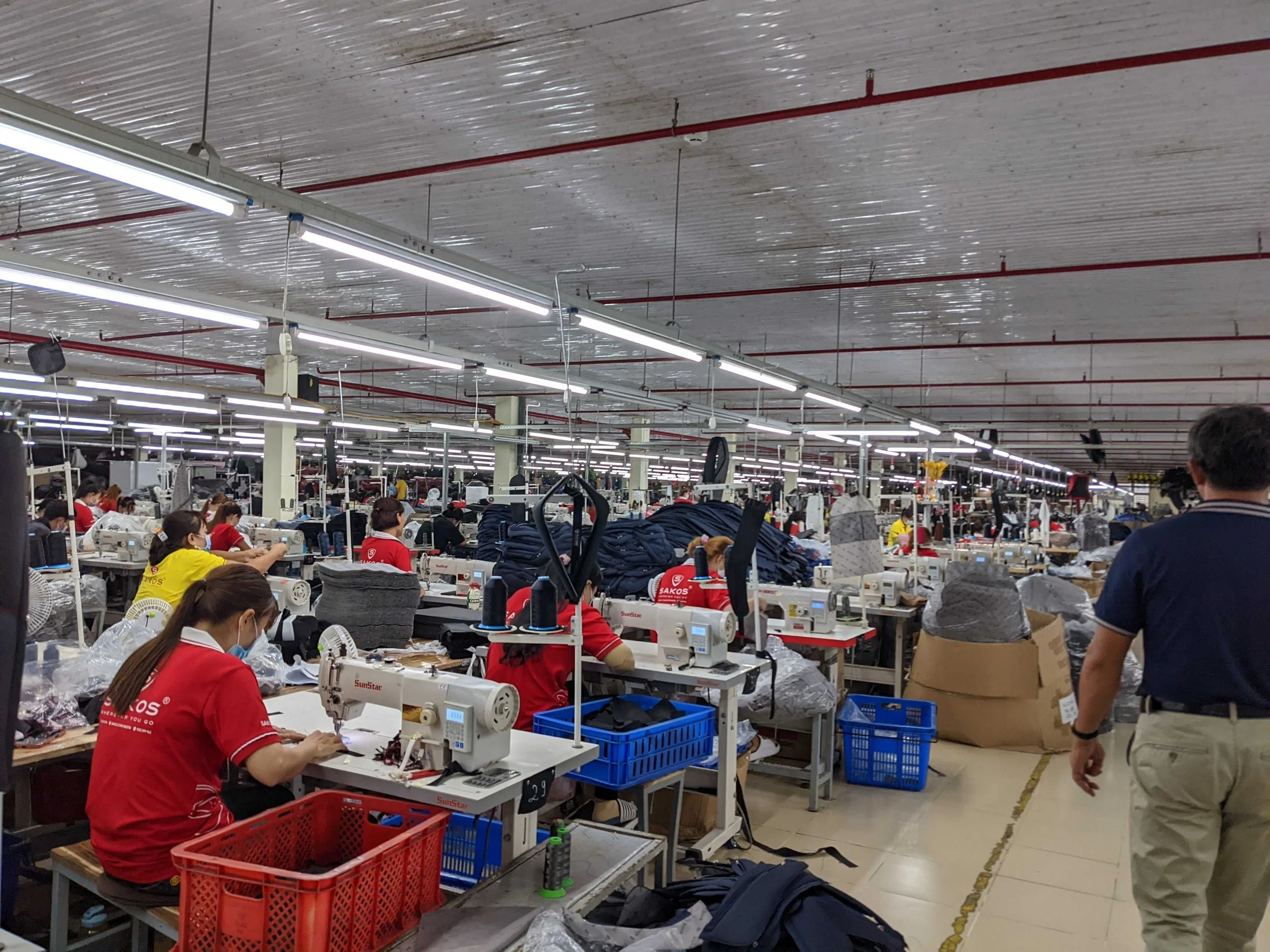 An export-grade Vietnam apparel production line with sewing machines and workers