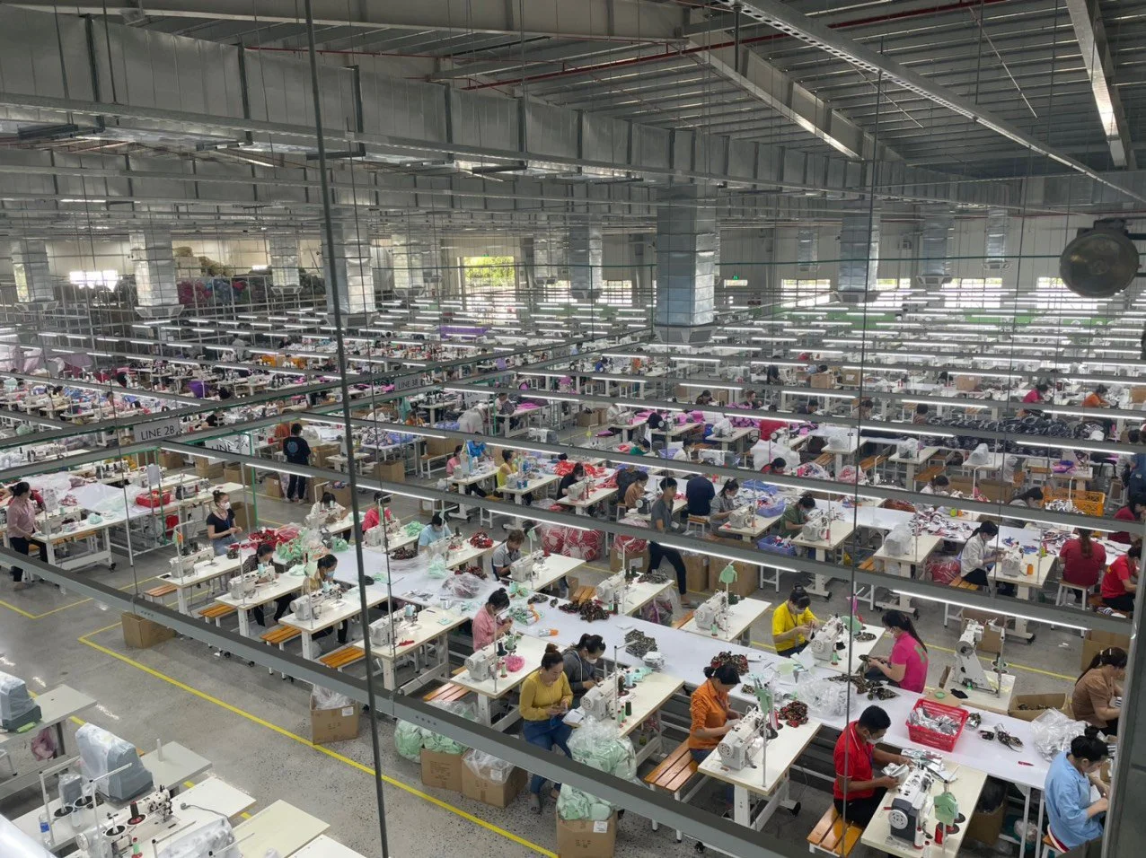 Inside a Vietnam clothing factory showing sewing lines and workstations